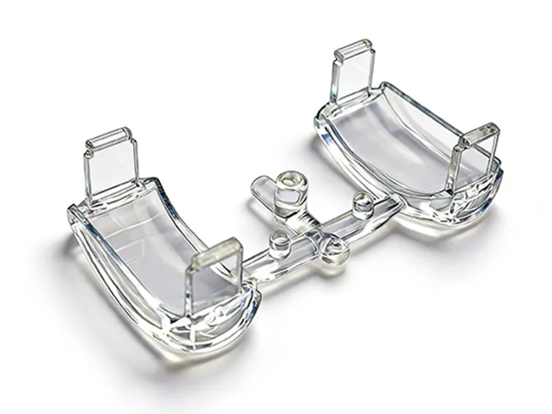 High-precision clear polycarbonate (PC) lens injection molded with runners for automotive lighting applications, produced by ATRMOLD.