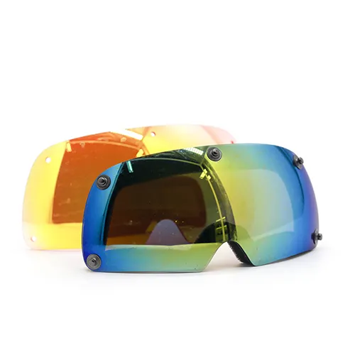 Finished protective goggle lenses with vibrant REVO mirror coatings and integrated mounting clips, showcasing multi-layered functional films for glare reduction and UV protection.