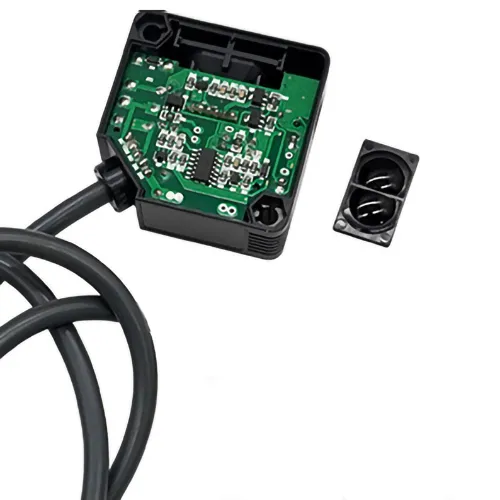Precision-molded dual-aperture sensor lens positioned next to its integrated PCB control module and housing, showcasing a complete photoelectric sensing assembly for industrial automation.