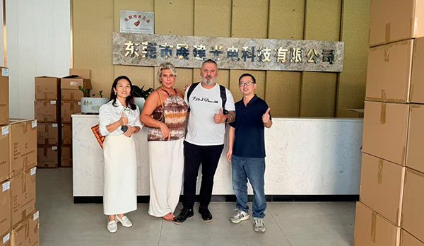 International guests from Turkey exploring manufacturing capabilities and discussing custom lens projects during a facility visit.
