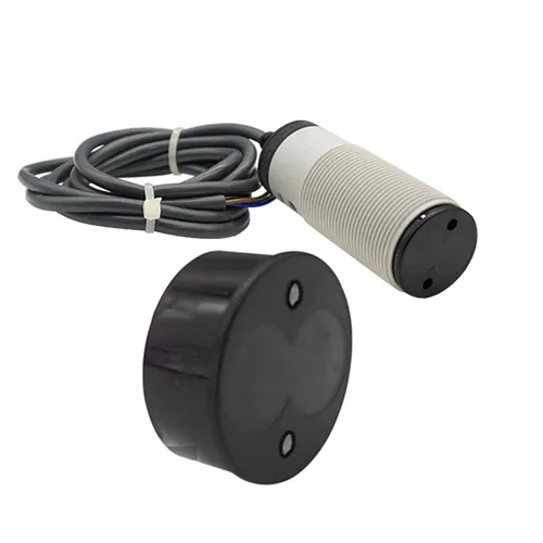 A cylindrical threaded infrared photoelectric sensor with a grey connection cable, displayed alongside a black circular infrared sensor switch housing component.